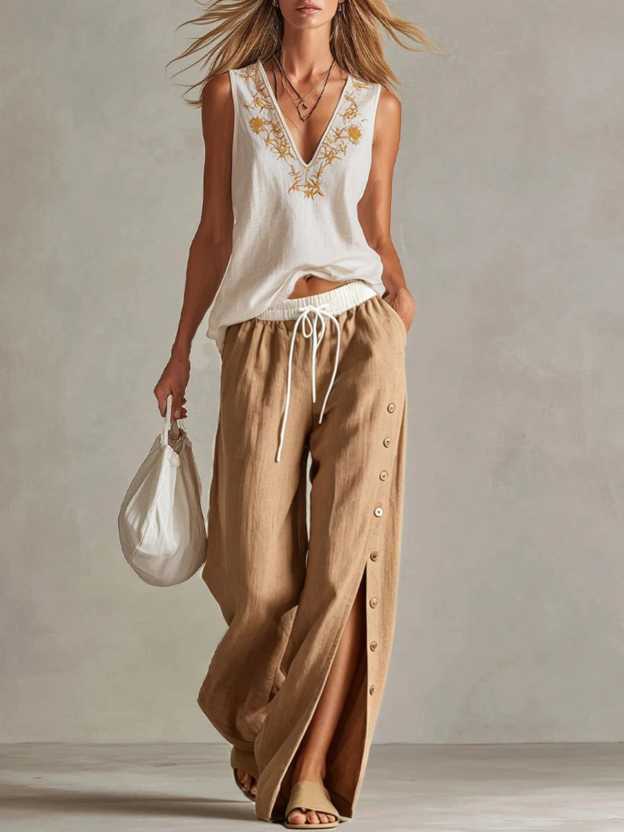 Completo casual da donna in cotone e lino: top senza maniche con scollo a V e vestibilità ampia e pantaloni a gamba larga a vita alta.