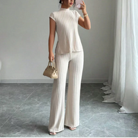 Completo a due pezzi composto da un elegante top a collo alto e pantaloni a gamba larga.