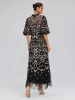 Abito in tulle con volant e ricami floreali