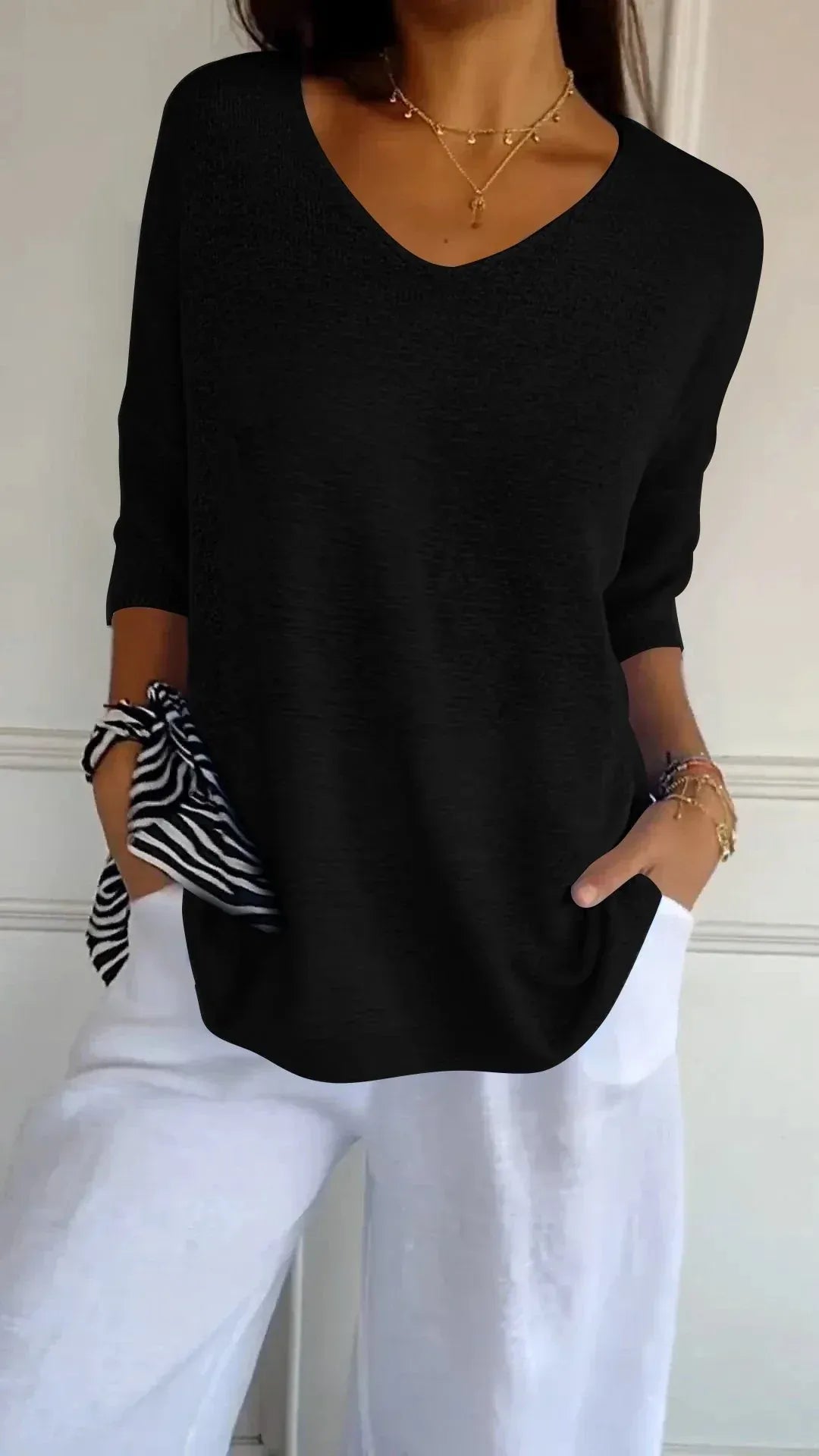 Top elegante in maglia a tinta unita con scollo a V