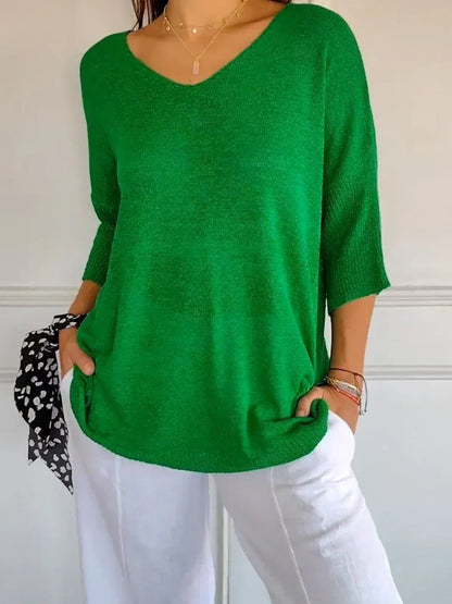 Top elegante in maglia a tinta unita con scollo a V
