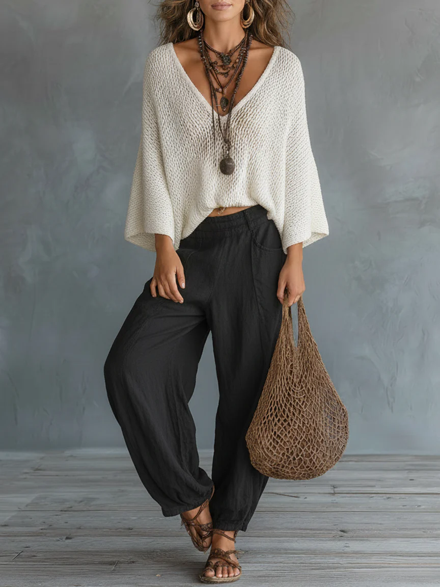 Set minimalista e leggero composto da maglione leggero con maniche a mantella e pantaloni harem